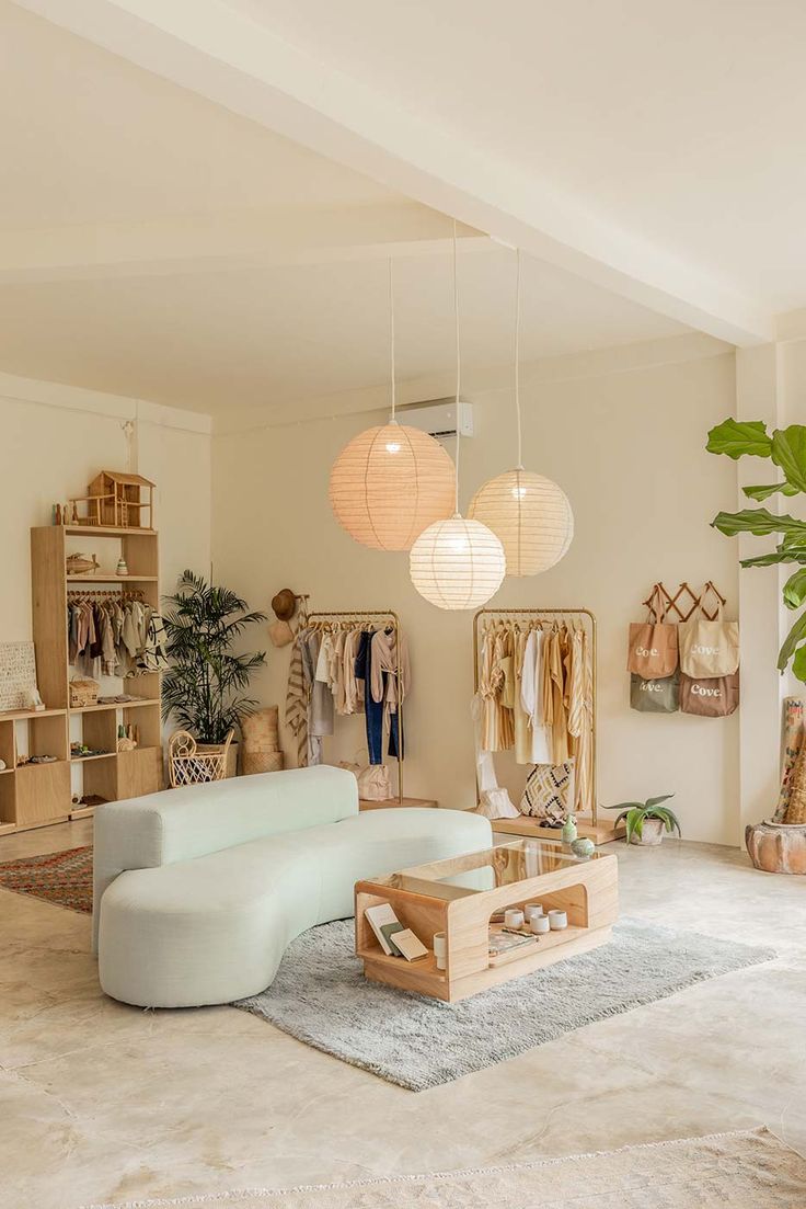 a living room filled with furniture and hanging lights