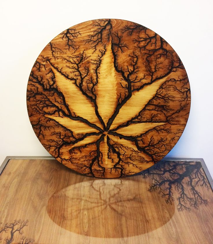 a wooden plate sitting on top of a table next to a white wall and floor