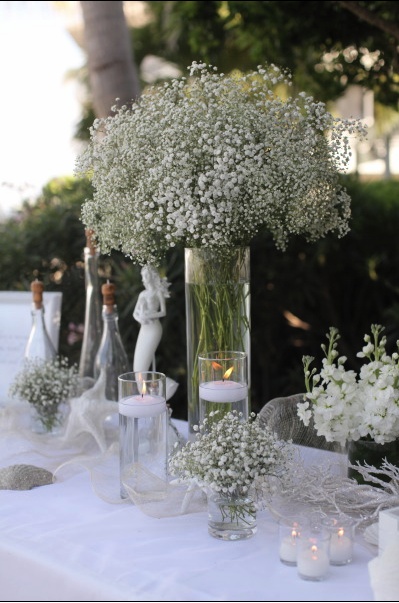 a table with flowers and candles on it