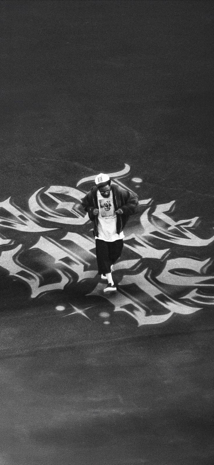 black and white photograph of a man walking in the street