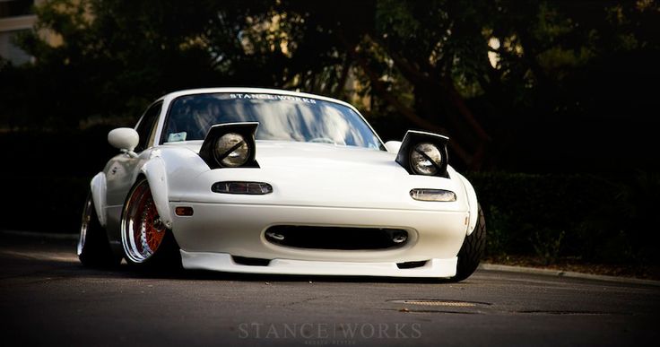 a white sports car parked on the street