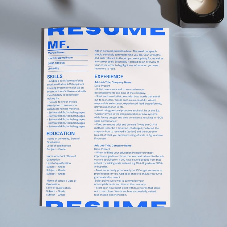 a blue and white resume sitting on top of a table next to a traffic light