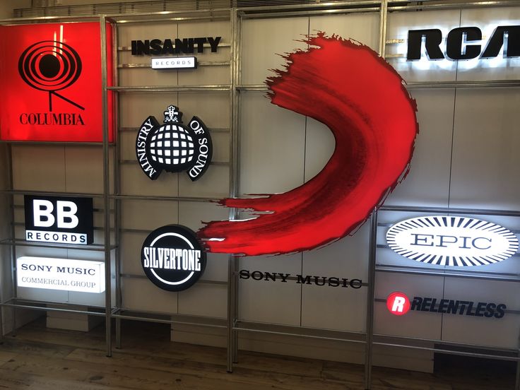 a wall that has various logos on it and some lights in the backround