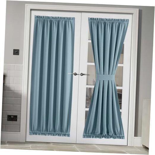 two blue curtains hanging on the side of a white door