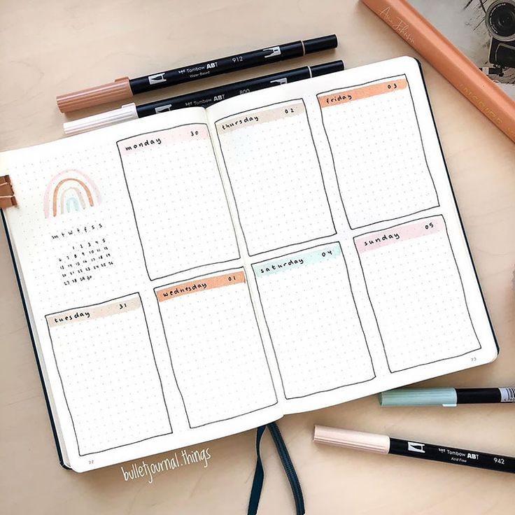 an open planner with pencils and markers