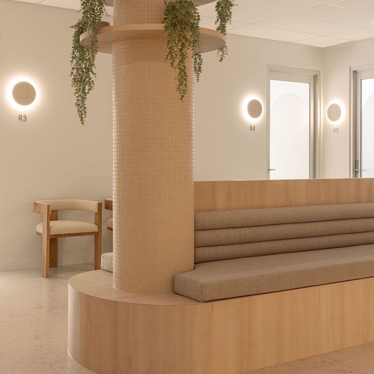 an empty waiting room with plants growing on the wall and flooring in front of it