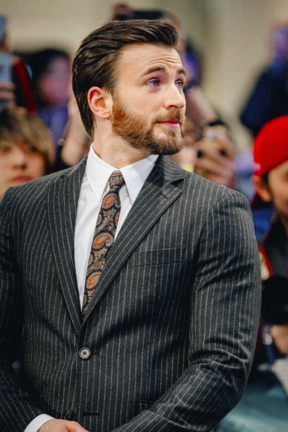 a man with a beard wearing a suit and tie