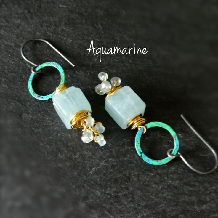 Stunning spotlights for your ears. Natural aquamarine Earrings. Mixed metal and stone earrings. Rustic earrings. Artisan earrings. Raw polished aquamarine cubes and aquamarine faseted beads dangle from a patina copper rings, wrapped with brass and hang on a hancrafted oxidized silver wire. One Of A Kind The earrings in total measure 5cm ( 1 31/32'') Come wrapped in a gift box. Aquamarine is first and foremost a stone of Courage. It helps to calm and soothe the nerves and reduce fear. It allows us to remain brave and strong in the midst of chaos. It also gives us courage to be our true, authentic selves. It aids in unblocking communication, so we can find the strength to have difficult conversations and speak our Truth. This stone supports us as we find our individuality and build the coura Handmade Gold Aquamarine Earrings, Aquamarine Dangle Earrings With Ear Wire, Aquamarine Drop Earrings With Ear Wire, Handmade Aquamarine Dangle Earrings, Gold Aquamarine Gemstone Earrings, Handmade Aquamarine Drop Earrings, Turquoise Aquamarine Dangle Earrings, Aquamarine Drop Earrings For Anniversary, Aquamarine Gemstone Earrings For Anniversary