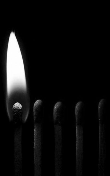 a group of matches are lit in the dark