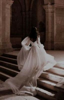 a woman in a white dress is walking up some steps with her back to the camera