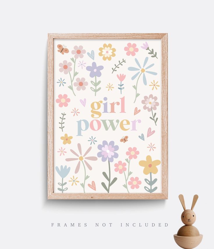 the girl power print is displayed next to a wooden toy and an empty vase with flowers on