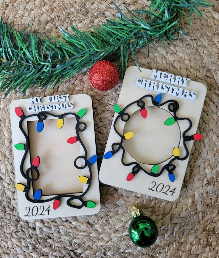 two christmas ornaments sitting on top of a table