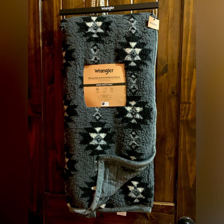 a blanket hanging on a door with a tag