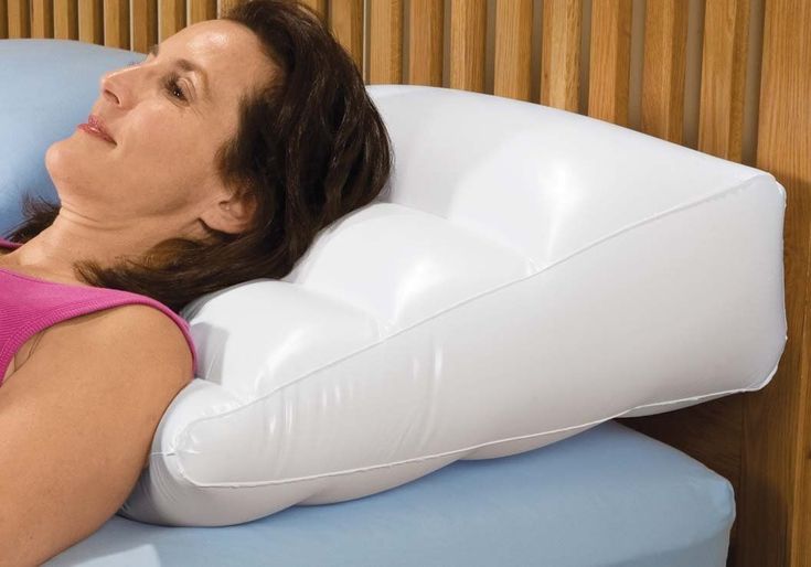 a woman laying down on a white pillow