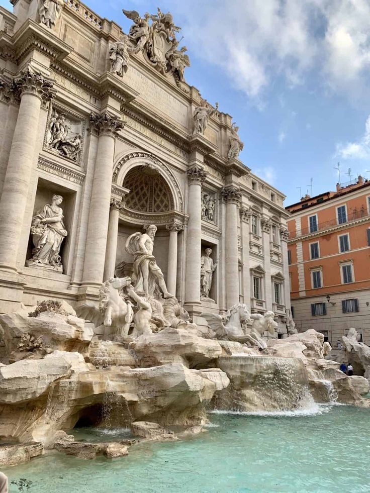 the trellotto di trelvia fountain in front of an orange and white building