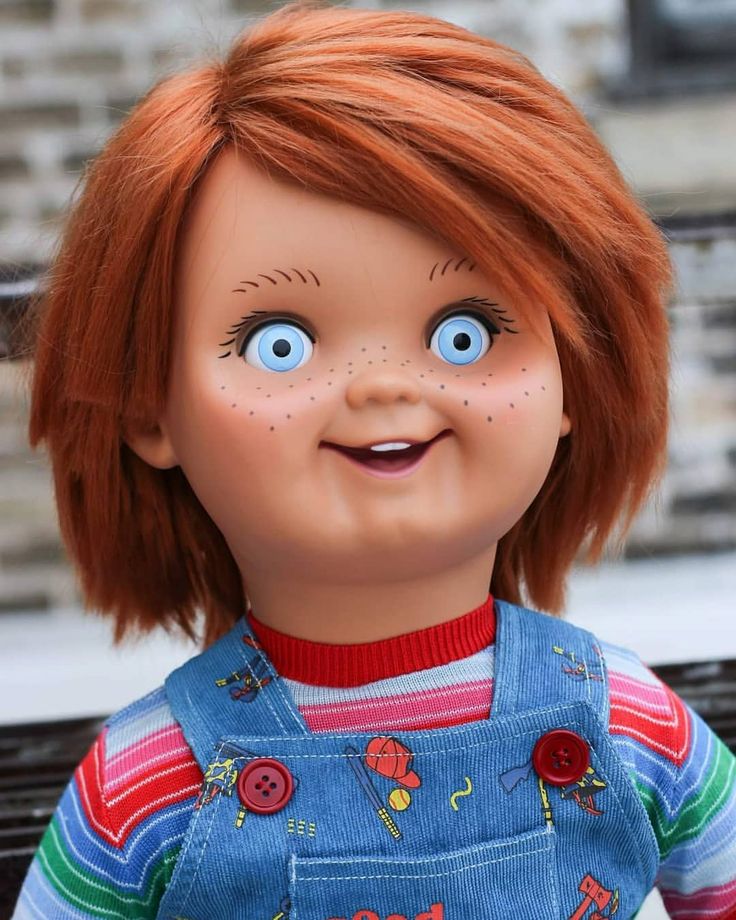 a doll with red hair and blue overalls