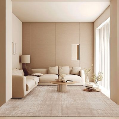 a modern living room with beige walls and carpeted flooring, white couches and coffee table