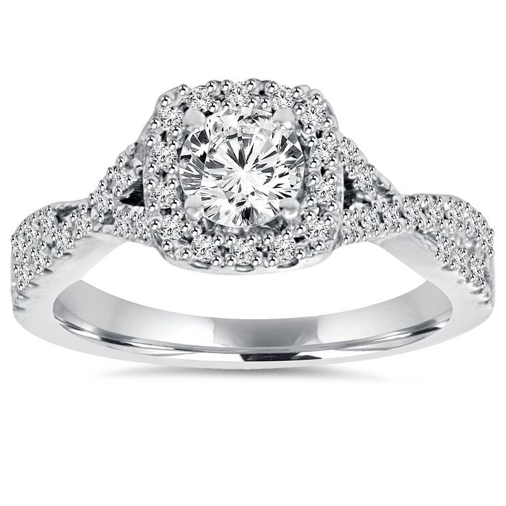 a white gold ring with diamonds on the band and an oval center stone surrounded by small round