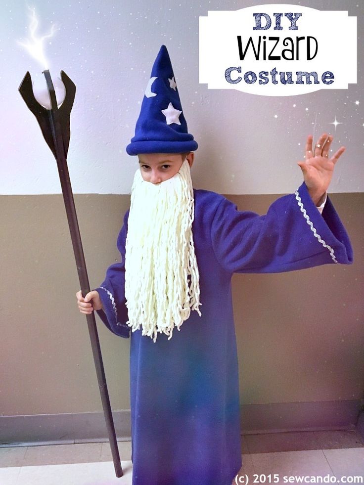 a man dressed in wizard costume holding a wand and wearing a hat with stars on it