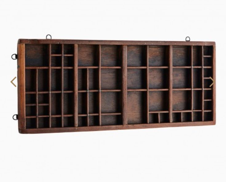 a wooden shelf with several compartments on it