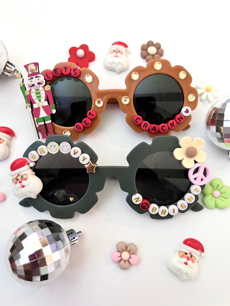 "CHRISTMAS SUNNIES!! These are so adorable-- Each pair is handcrafted by me. Using various beads, Charms, Rhinestones, and fun details! ♥️💚 *2 options available-- Choose your style:  1. LETS GET CRACKIN 2. GROOVY AND BRIGHT * Anti-Glare * UV Protection (UVA & UVB) * Durable and shatterproof  * They open and close smoothly  * Each item is made to order and will be ready to ship in 5-7 business days! If you need your order sooner. Please check out my \"RUSH ORDER OPTION\".  https://www.etsy.com/EyeCandyandFluff/listing/1286351273/rush-my-order-please *SHOP DISCLAIMER/WAIVER!  * Do NOT let your child put the sunglasses in their mouth as beads can become detached.    Always monitor and supervise while children are wearing these. The shop assumes no responsibility for sunglasses made. Sizing-- Fun Handmade Sunglasses As A Gift, Fun Handmade Sunglasses For Parties, Fun Handmade Sunglasses For Party, Handmade Fun Plastic Sunglasses, Handmade Plastic Fun Sunglasses, Fun Handmade Plastic Sunglasses, Playful Handmade Plastic Sunglasses, Fun Handmade Adjustable Sunglasses, Trendy Handmade Sunglasses For Gift