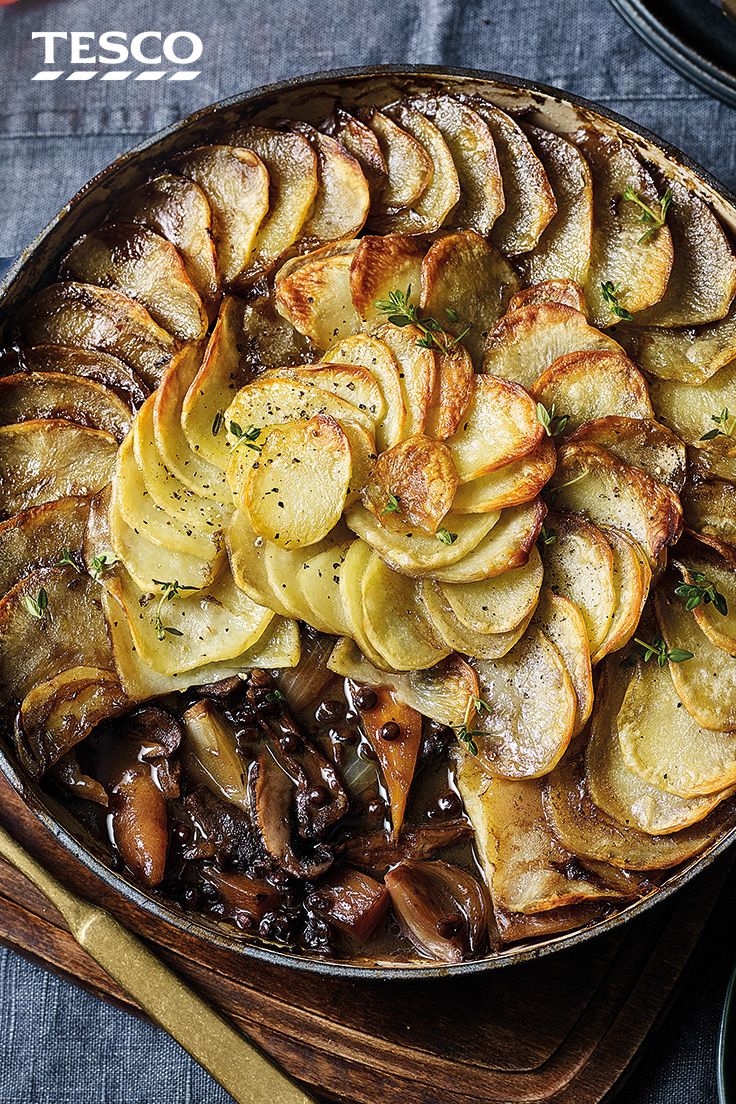 a dish with potatoes and mushrooms in it