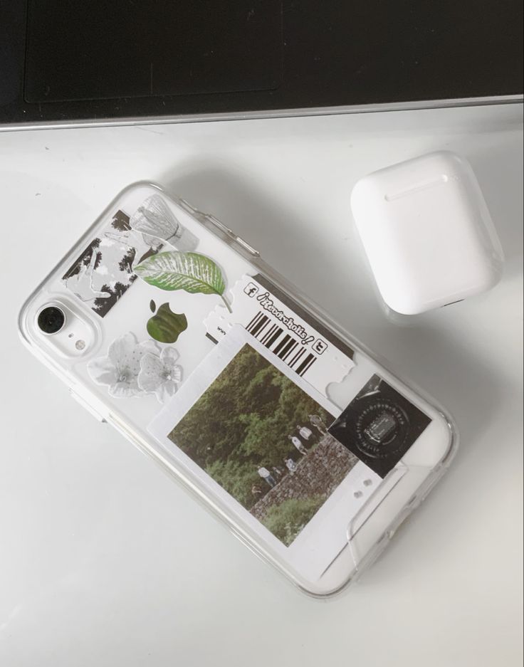 an apple phone sitting on top of a table next to a white mouse and keyboard