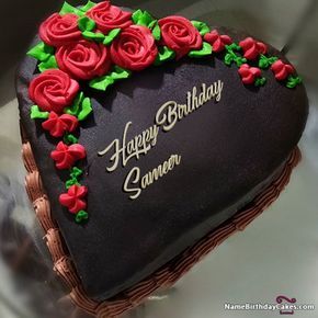 a heart shaped birthday cake with roses on it