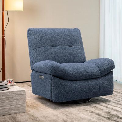 a blue recliner chair in a living room with a lamp on the side table