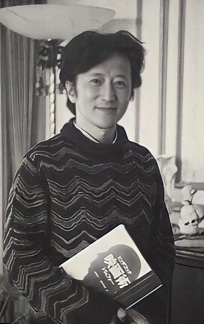 an old photo of a woman holding a book in her hands and smiling at the camera