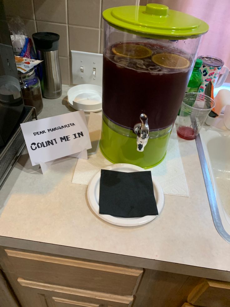 a blender sitting on top of a counter next to a sign that says count me in