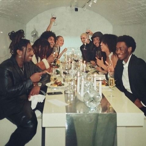 a group of people sitting around a table with wine glasses