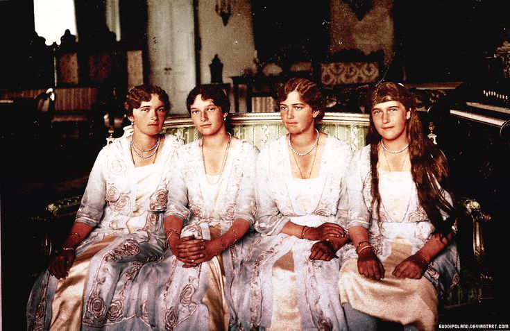 four women in white dresses sitting next to each other