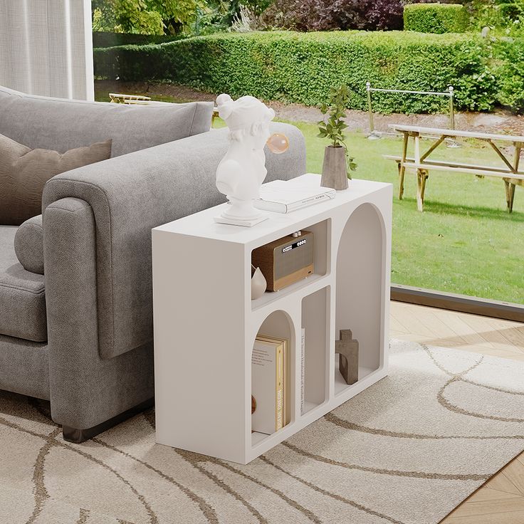 a living room scene with focus on the sofa and coffee table in the foreground