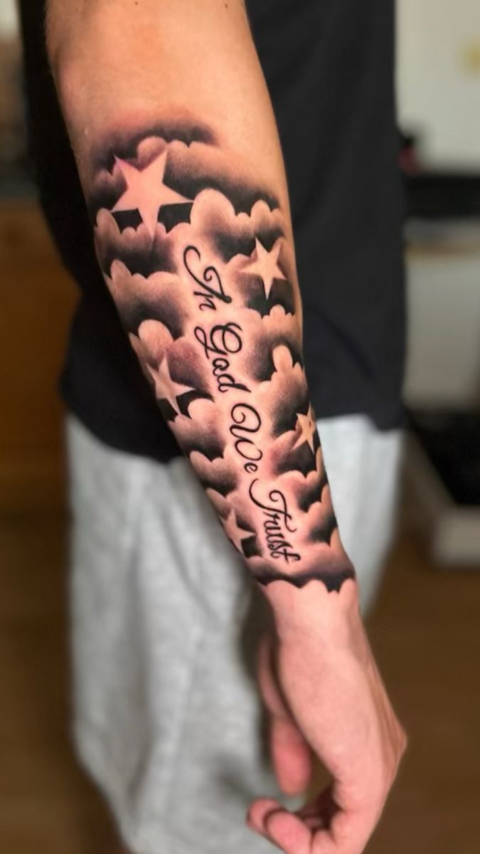 a man with a cloud and stars tattoo on his arm