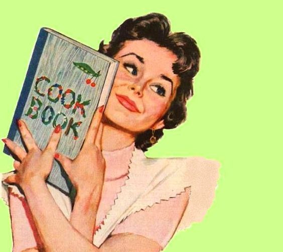 a woman holding up a cook book in front of her face with the words cook book written on it