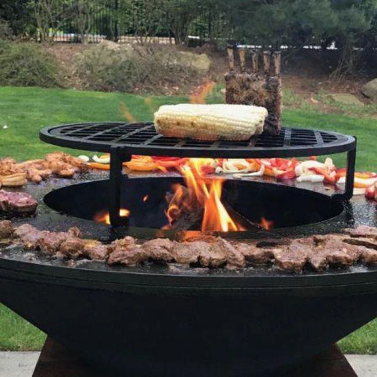 an outdoor grill with food cooking on it