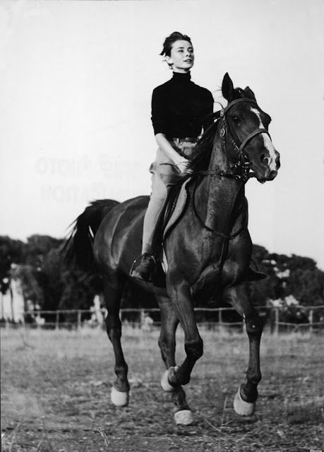 a woman riding on the back of a brown horse