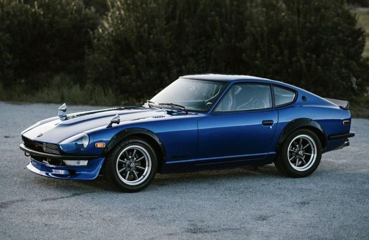 a blue sports car parked in a parking lot