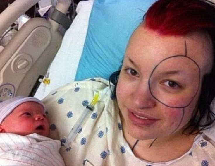 a woman with red hair holding a baby