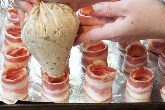 a person holding a bag filled with meat wrapped in bacon