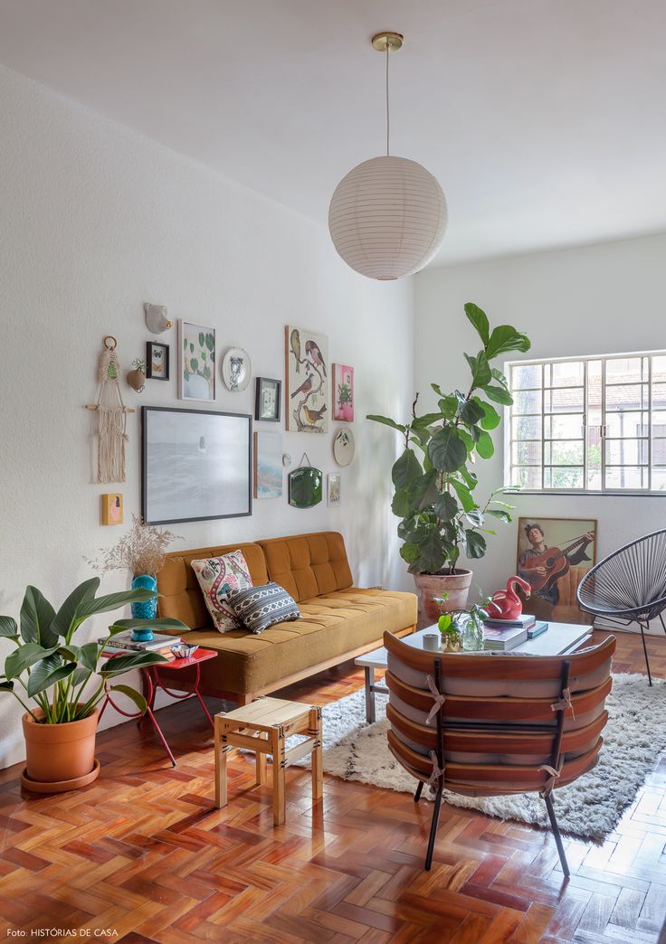 a living room filled with furniture and lots of plants