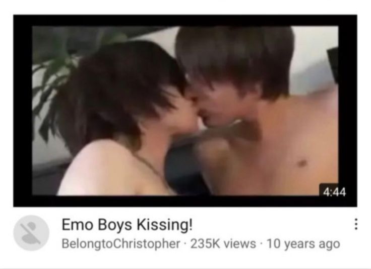 two people kissing each other in front of a screen with the caption'emo boys kissing '