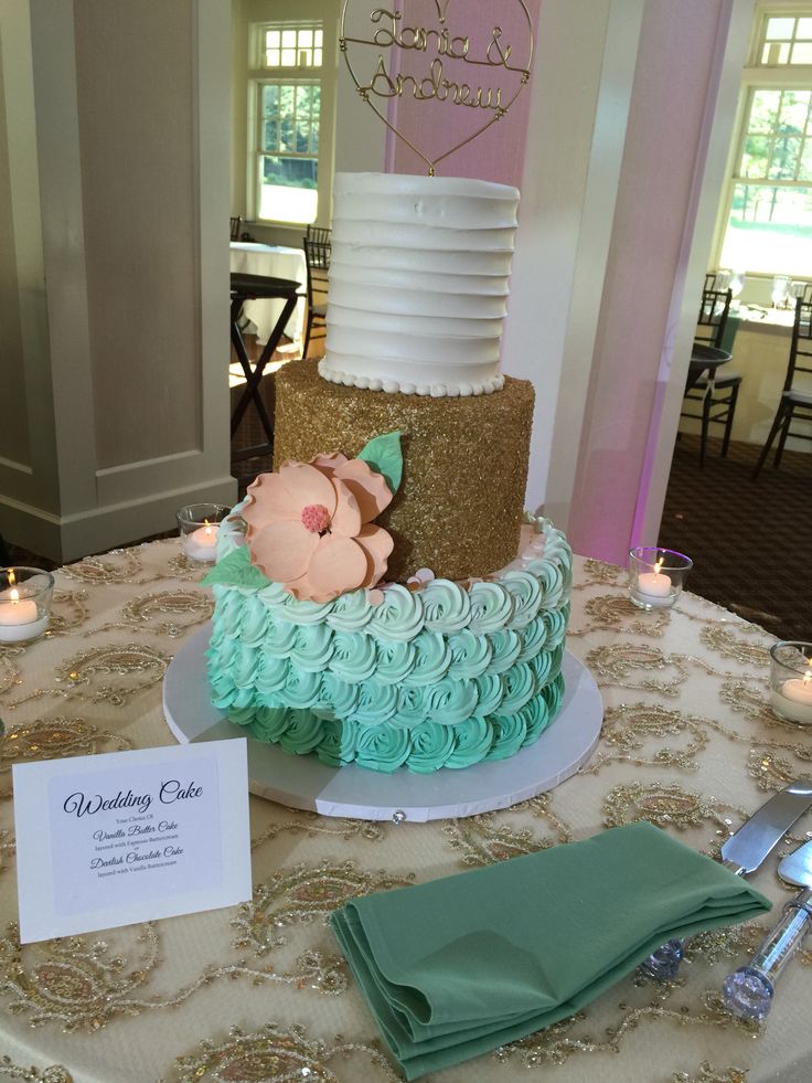 a wedding cake on a table with candles and place cards for guests to eat it