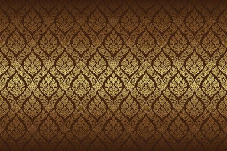 a gold and brown wallpaper with intricate designs