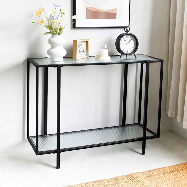 a console table with two candles on it