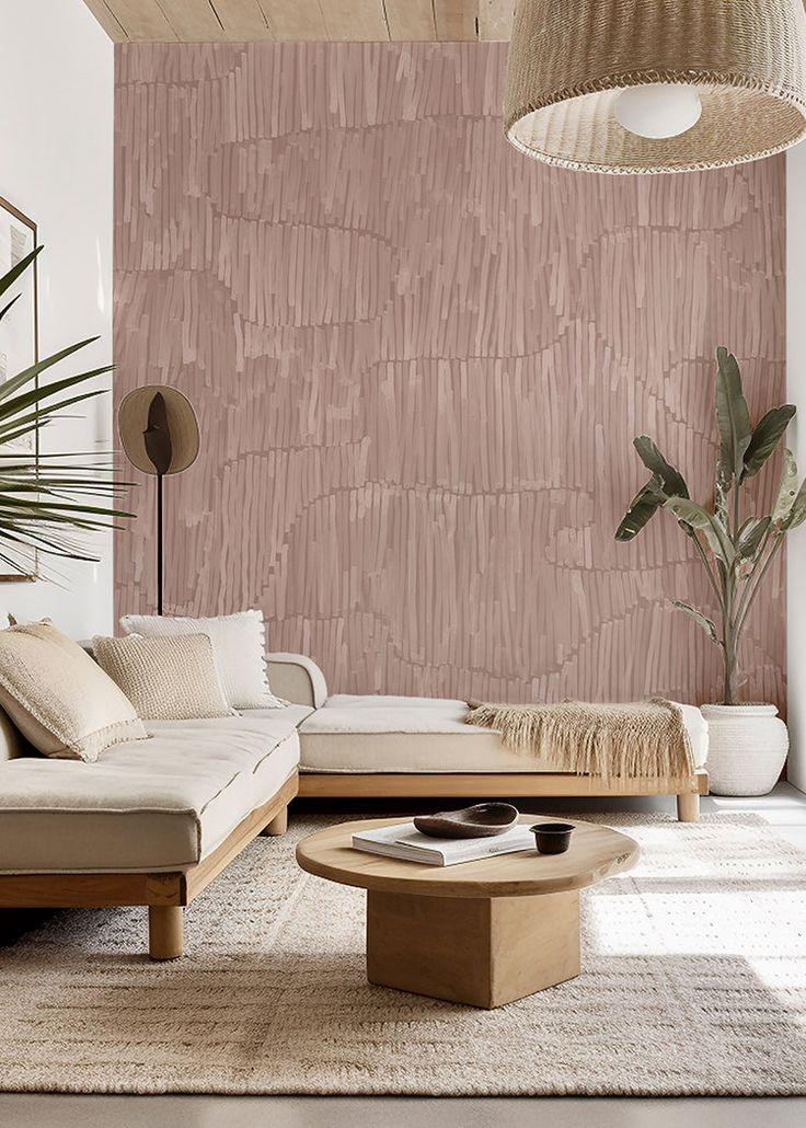 a living room with pink wallpaper and wooden furniture in the corner, along with a large potted plant