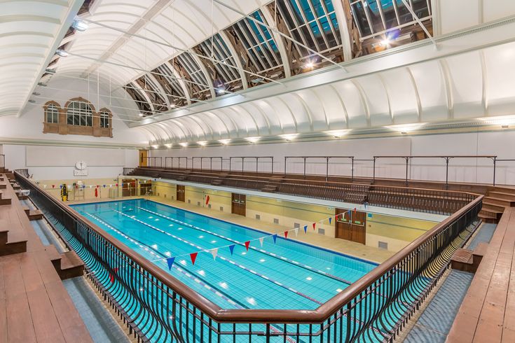 an indoor swimming pool in a large building