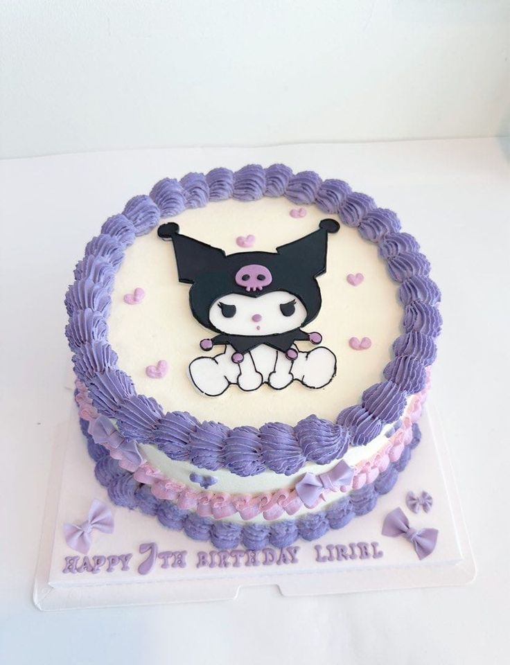 a birthday cake decorated with an image of a cat on the top and purple icing