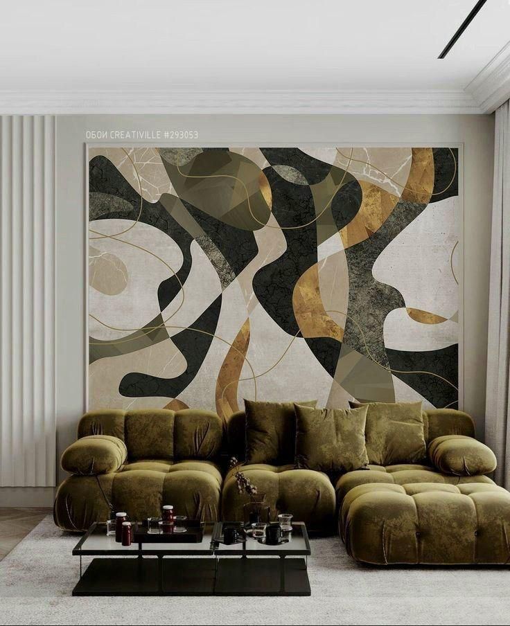 a living room with a large painting on the wall and couches in front of it